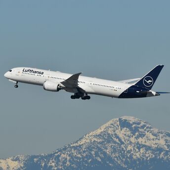 Lufthansa passenger jet flying above a snow-covered mountain