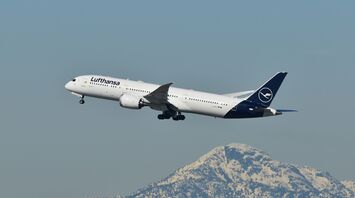 Lufthansa passenger jet flying above a snow-covered mountain