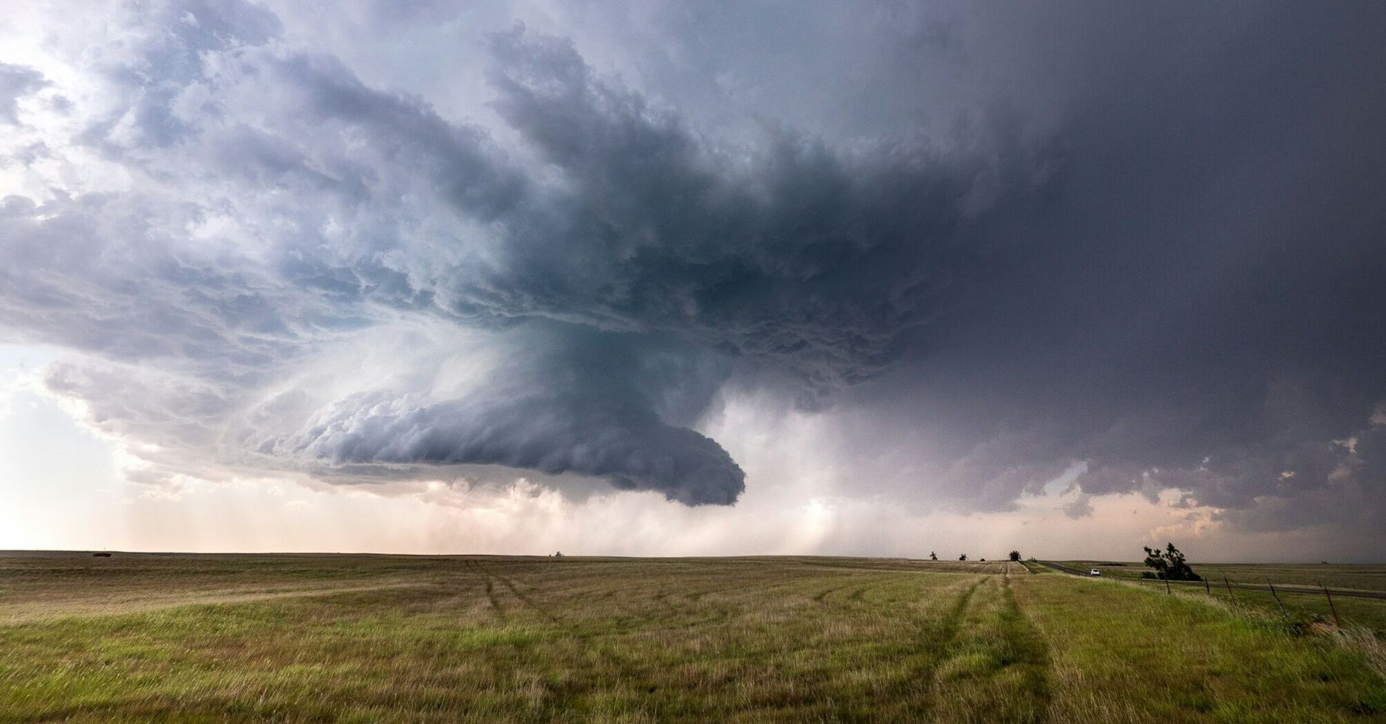 Massive storm clouds over an open field