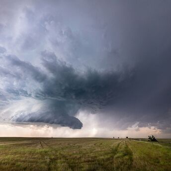 Massive storm clouds over an open field