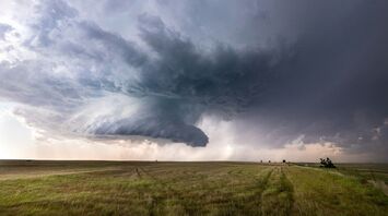 Massive storm clouds over an open field