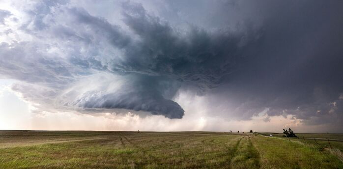 Massive storm clouds over an open field