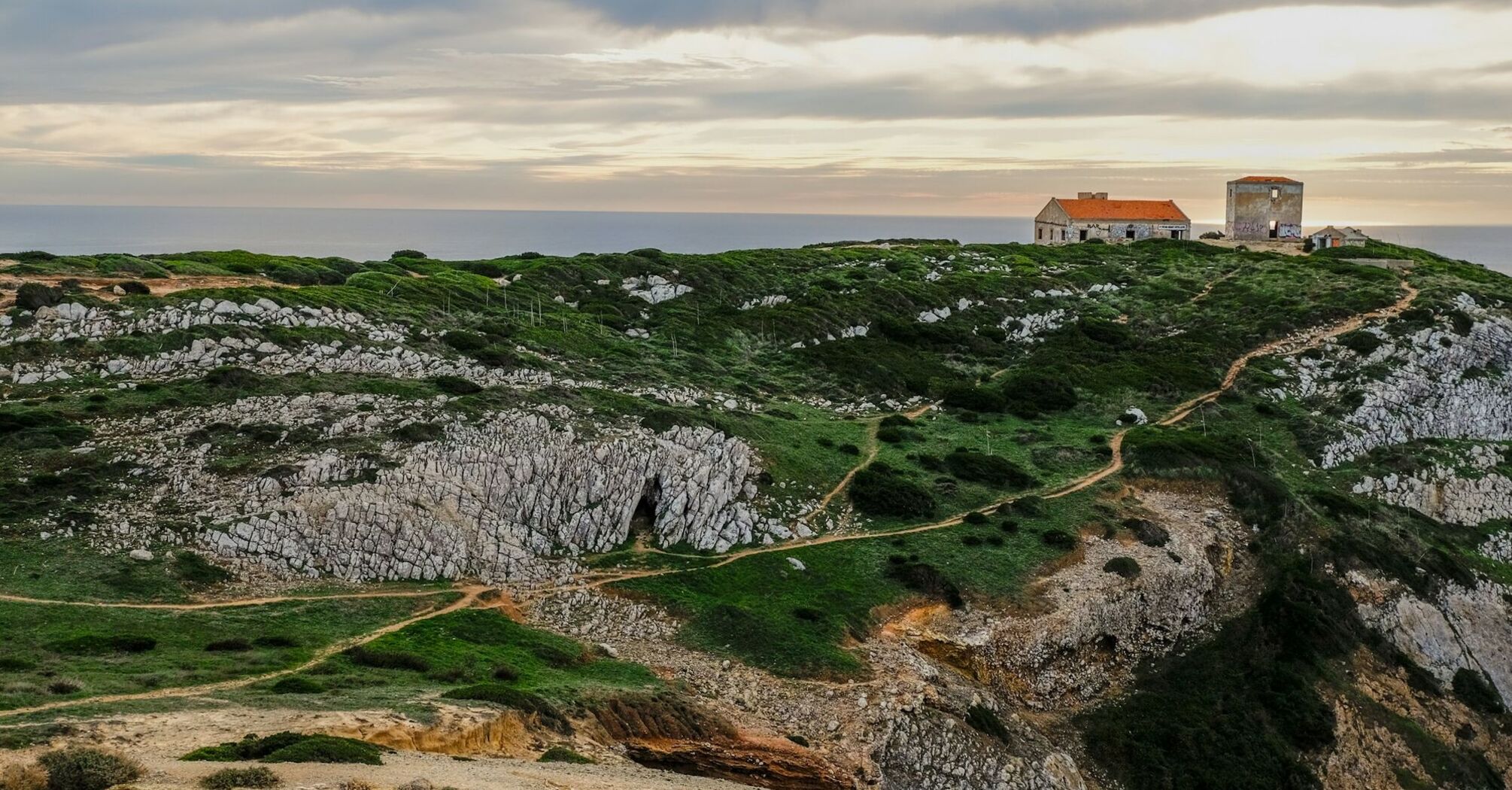 Rocky coastal cliffs and clifftop buildings in Portugal