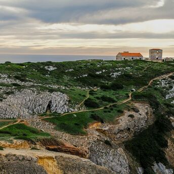 Rocky coastal cliffs and clifftop buildings in Portugal