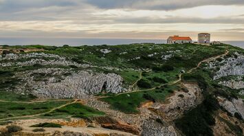 Rocky coastal cliffs and clifftop buildings in Portugal