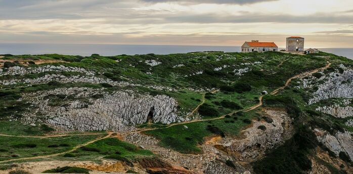Rocky coastal cliffs and clifftop buildings in Portugal