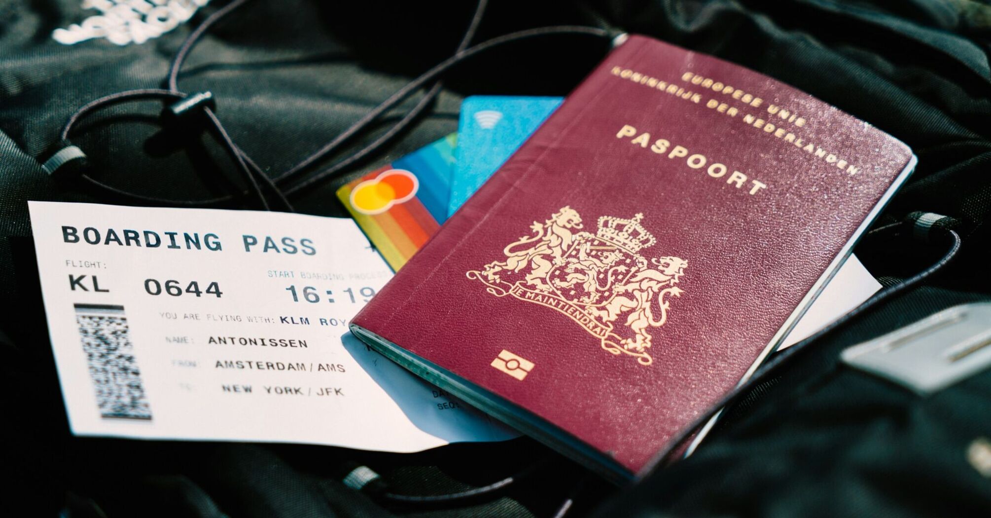Dutch passport and boarding pass for an Amsterdam–New York flight