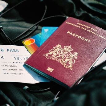 Dutch passport and boarding pass for an Amsterdam–New York flight