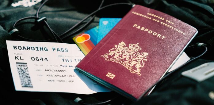 Dutch passport and boarding pass for an Amsterdam–New York flight