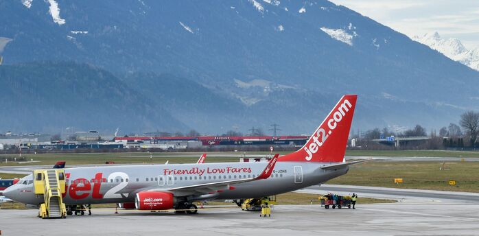 Jet2 aircraft parked at an airport with mountains in the background