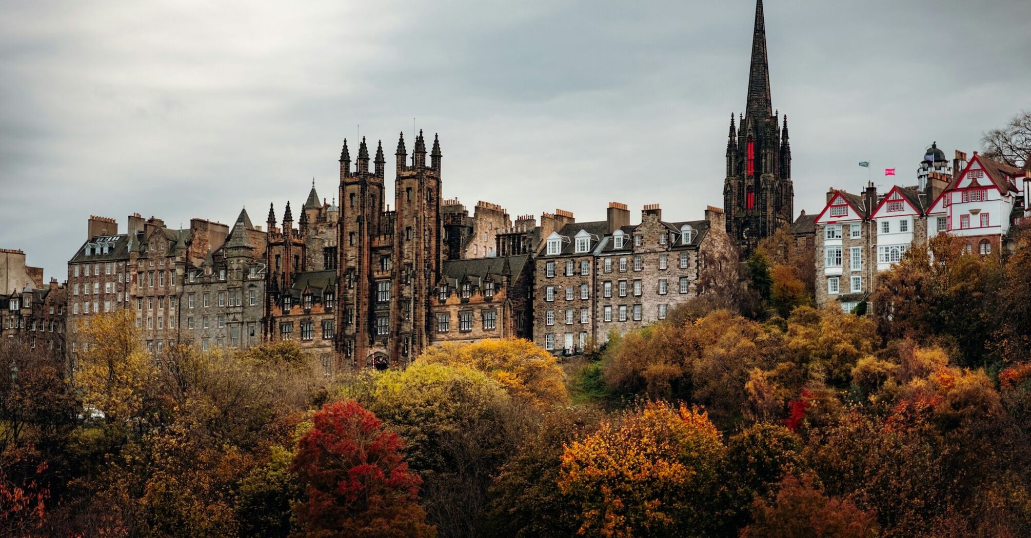 Historic Edinburgh skyline with Gothic buildings and autumn trees