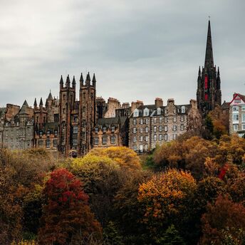 Historic Edinburgh skyline with Gothic buildings and autumn trees