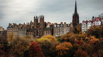 Historic Edinburgh skyline with Gothic buildings and autumn trees