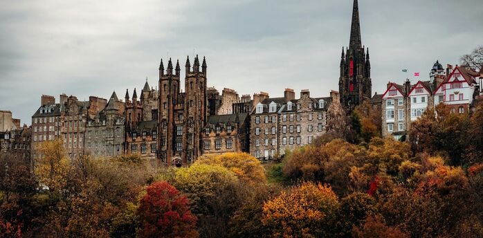 Historic Edinburgh skyline with Gothic buildings and autumn trees