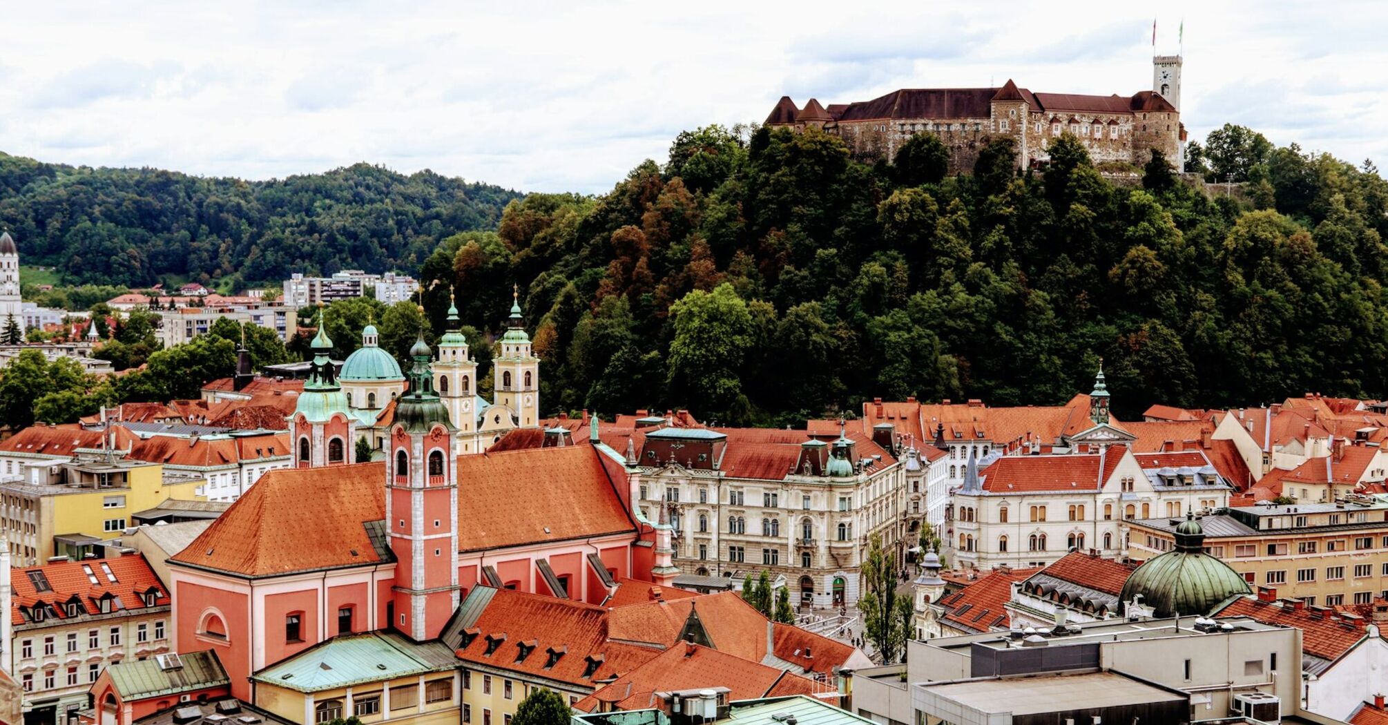Ljubljana’s historic old town with red rooftops and Ljubljana Castle on the hill