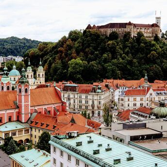 Ljubljana’s historic old town with red rooftops and Ljubljana Castle on the hill