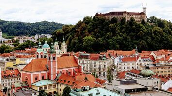 Ljubljana’s historic old town with red rooftops and Ljubljana Castle on the hill