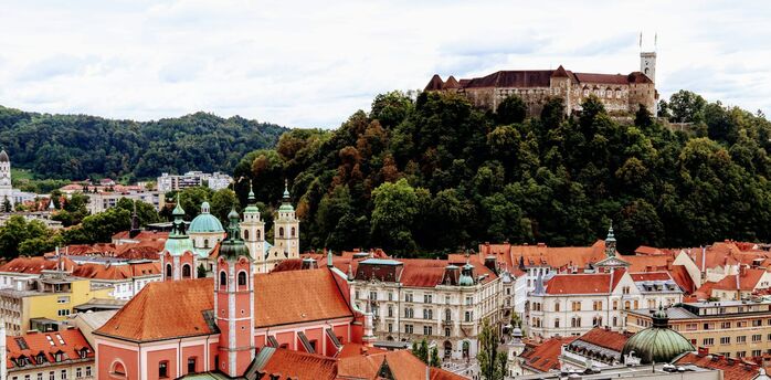 Ljubljana’s historic old town with red rooftops and Ljubljana Castle on the hill