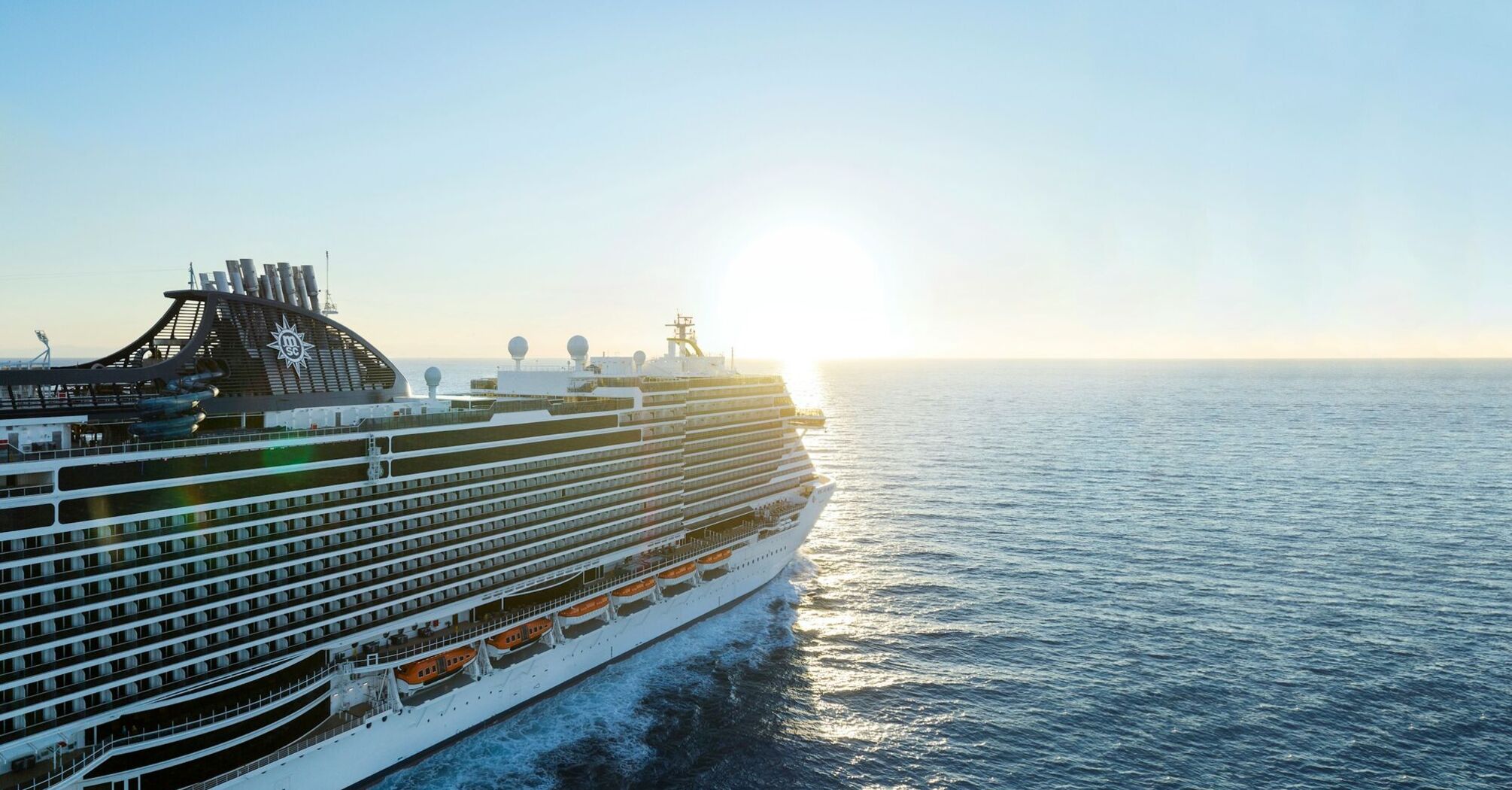 MSC cruise ship sailing at sunset