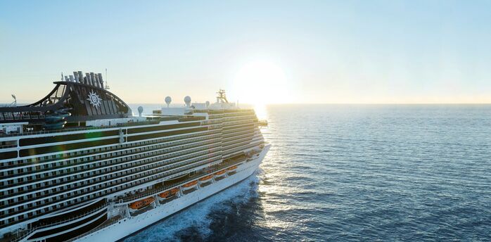 MSC cruise ship sailing at sunset