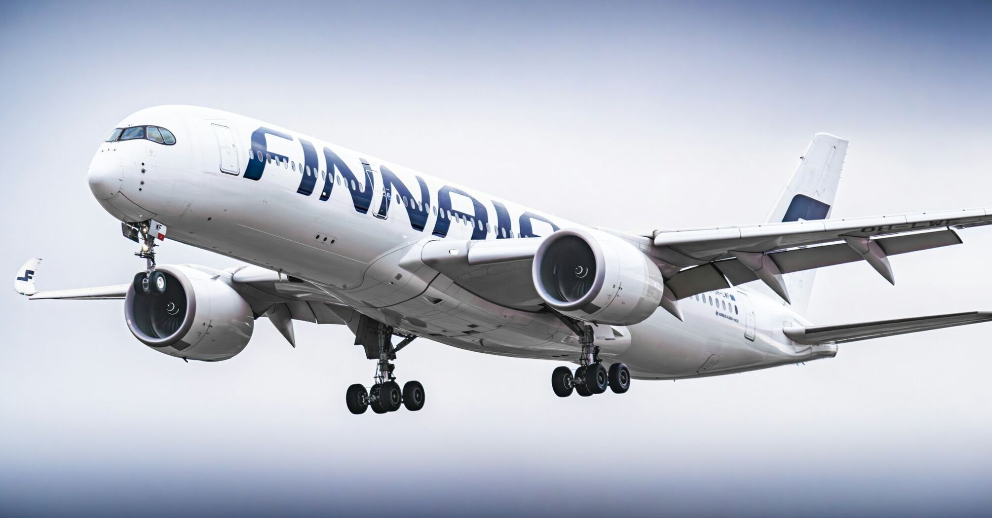 Finnair Airbus A350 aircraft in flight with landing gear extended