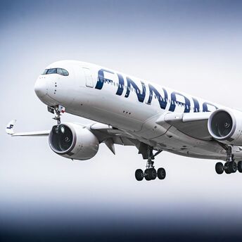 Finnair Airbus A350 aircraft in flight with landing gear extended