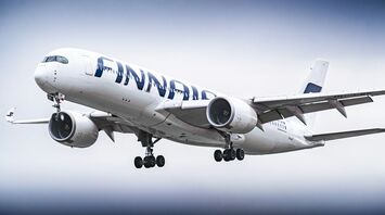 Finnair Airbus A350 aircraft in flight with landing gear extended