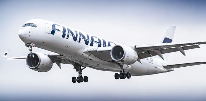 Finnair Airbus A350 aircraft in flight with landing gear extended