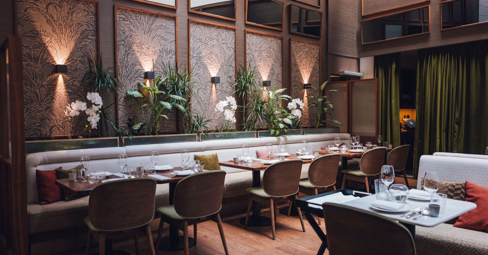 Set tables and indoor plants at Brasserie Sophie in Vienna