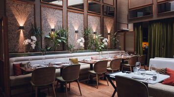 Set tables and indoor plants at Brasserie Sophie in Vienna