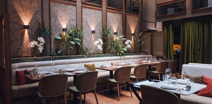 Set tables and indoor plants at Brasserie Sophie in Vienna