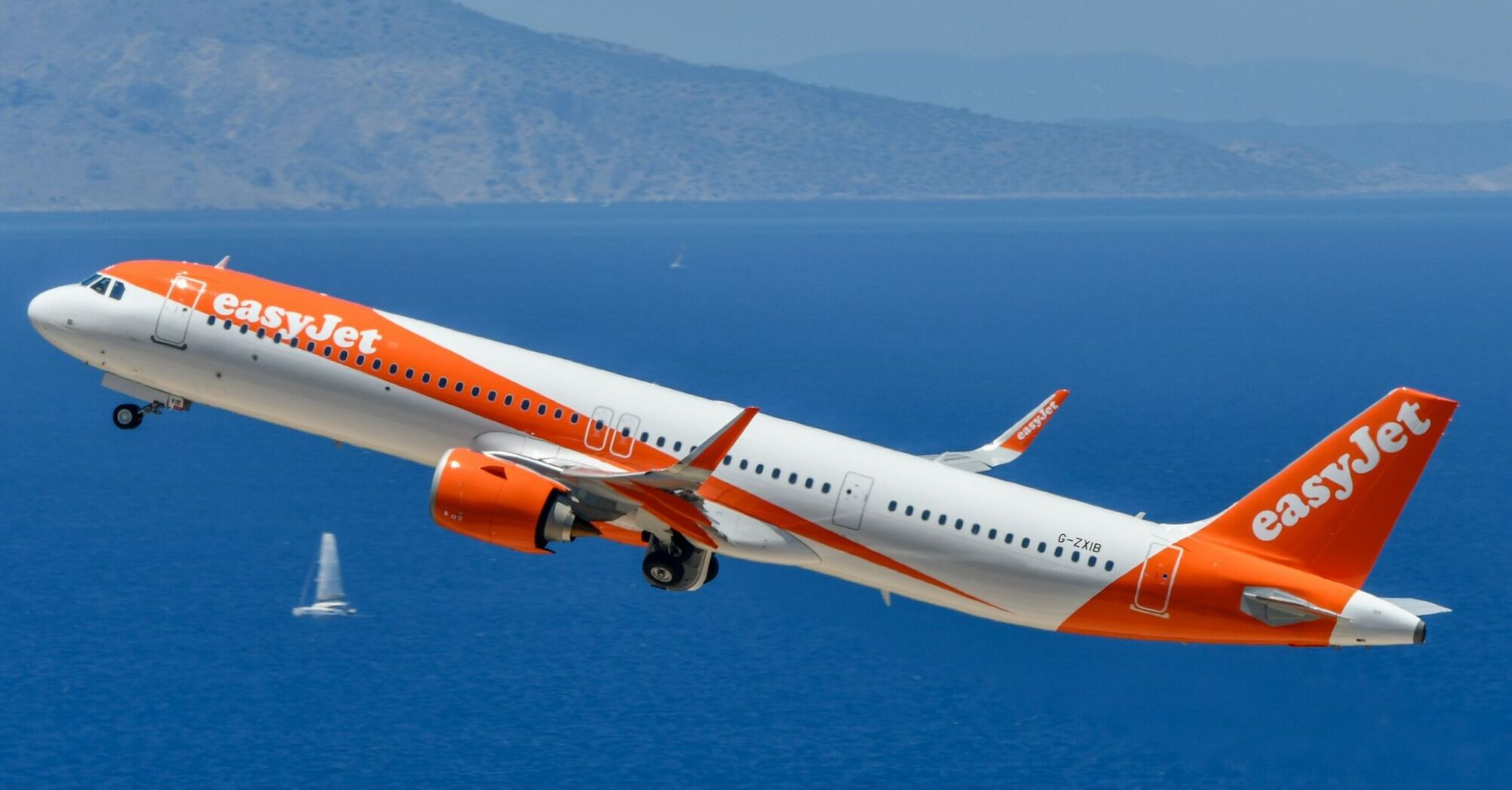 easyJet passenger aircraft taking off above the sea