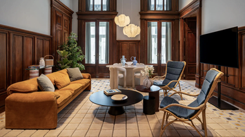 Elegant Andaz Lisbon interior with an orange sofa, wooden panelling and modern furniture