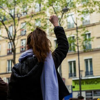 Woman raising her fist during a street protest