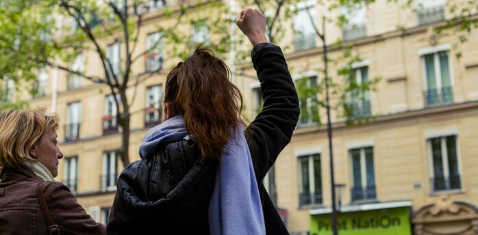 Woman raising her fist during a street protest