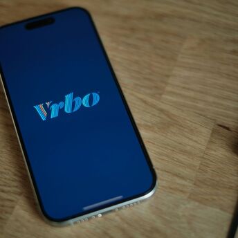 Vrbo logo on a smartphone screen