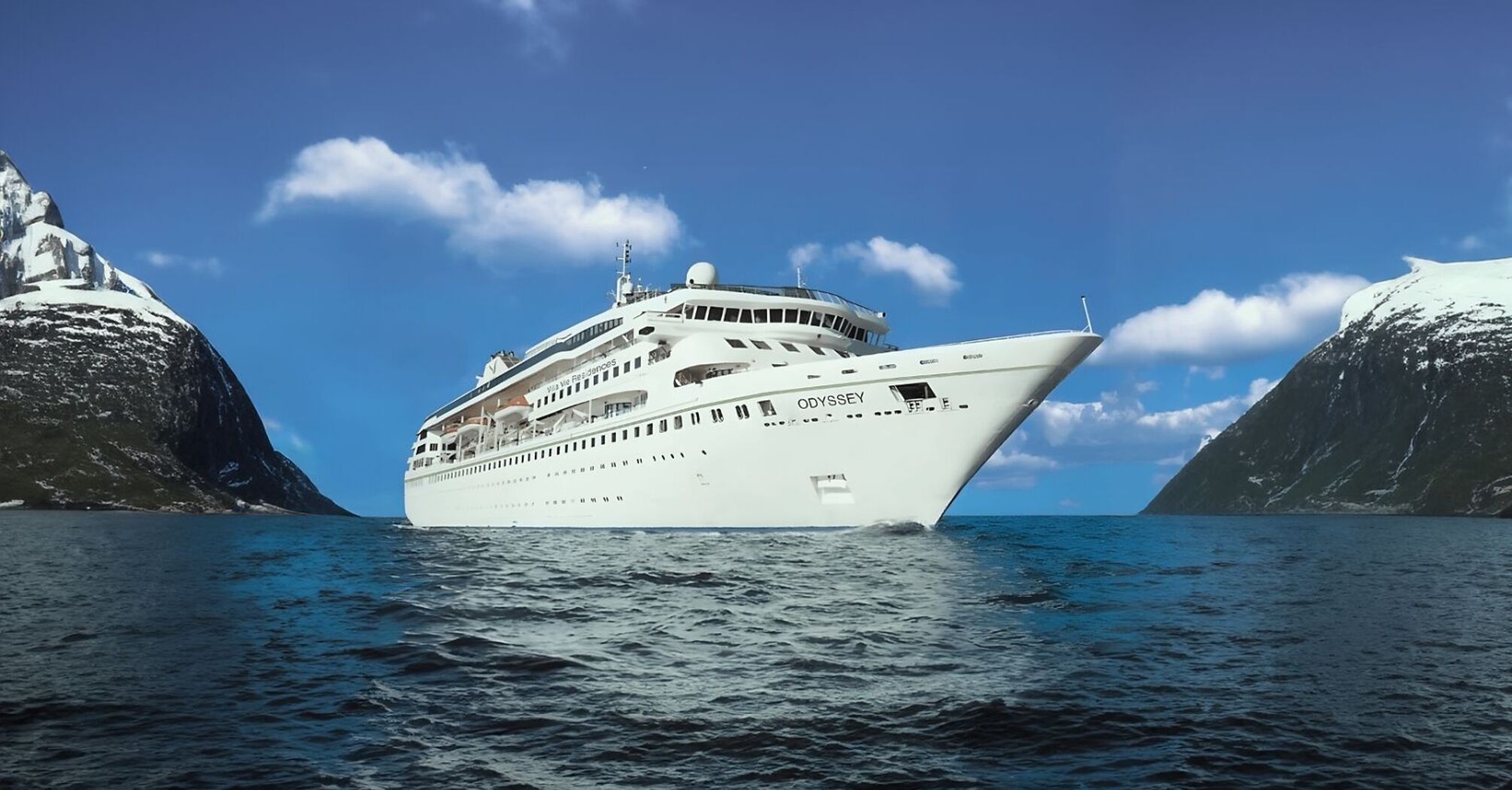 Villa Vie Odyssey cruise ship sailing between snow-covered mountains