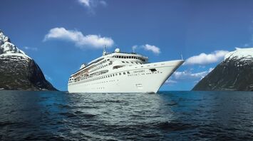 Villa Vie Odyssey cruise ship sailing between snow-covered mountains