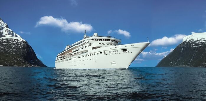 Villa Vie Odyssey cruise ship sailing between snow-covered mountains