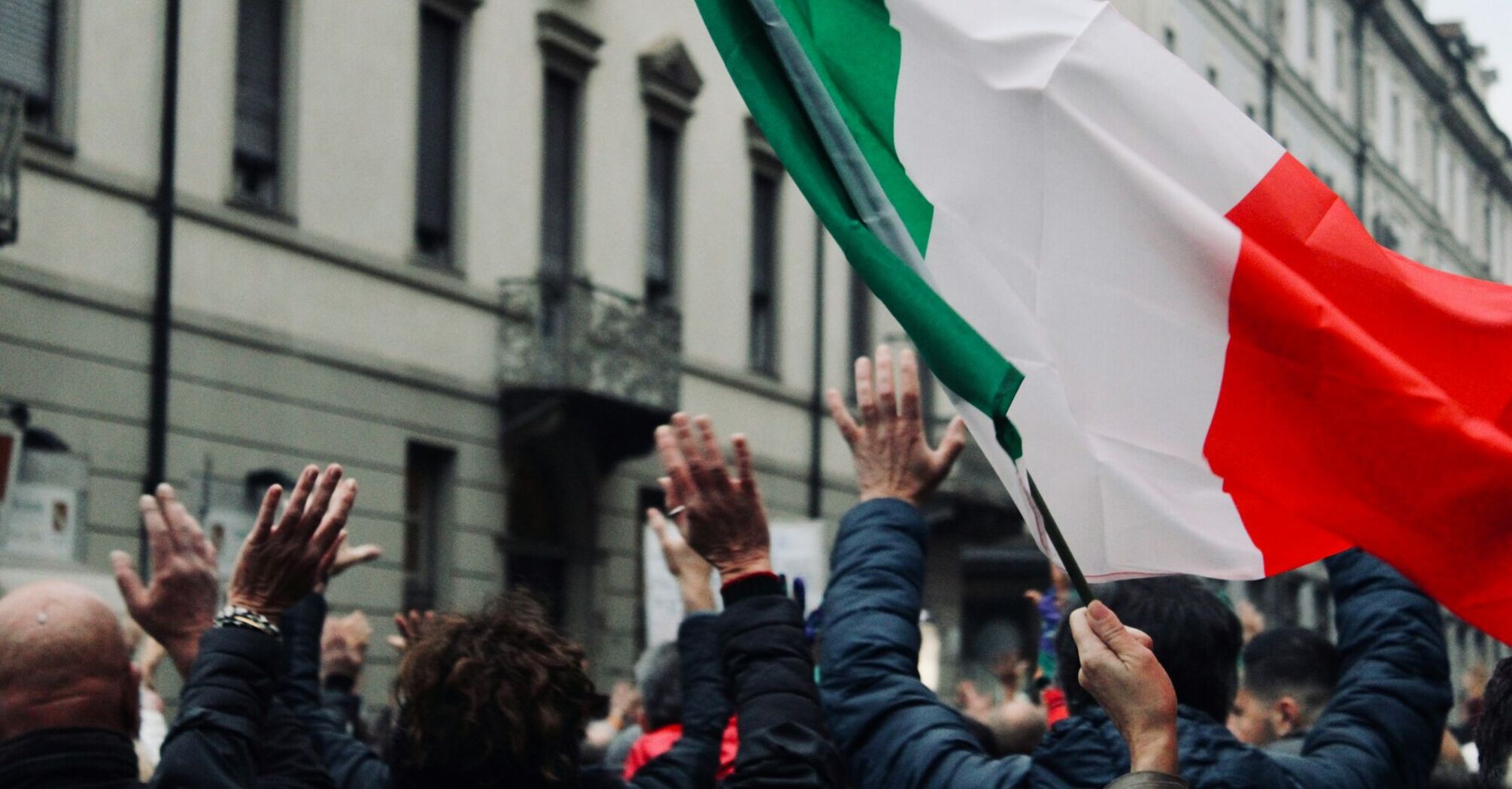 Crowd waving an Italian flag during a demonstration