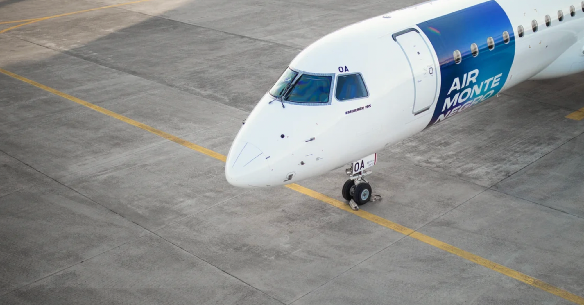 Air Montenegro Embraer 195 aircraft parked on an airport apron