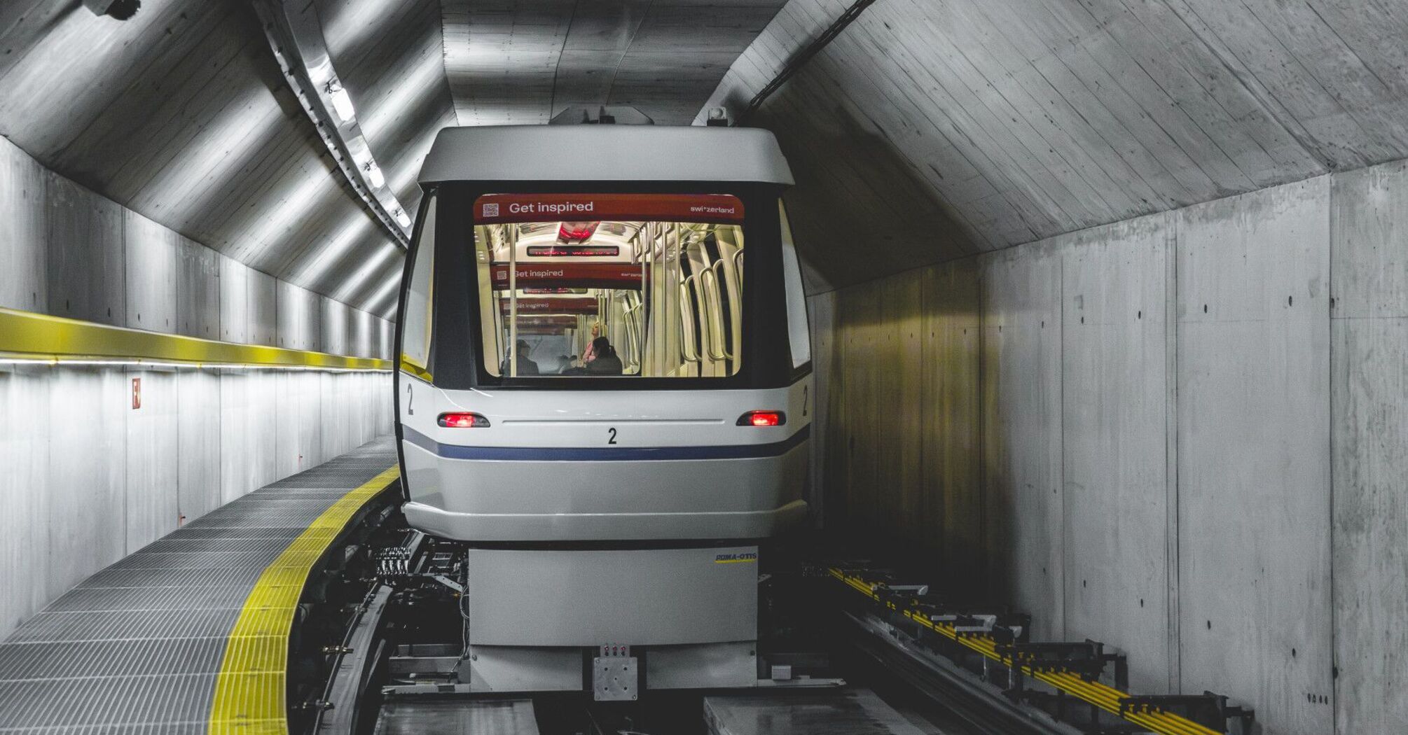 Skymetro train travelling through a tunnel at Zurich Airport