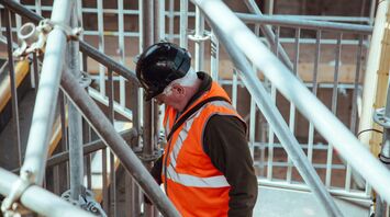 Rail worker among station scaffolding