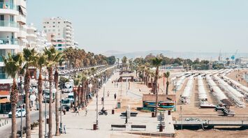 Palm-lined seafront and beach in Larnaca, Cyprus