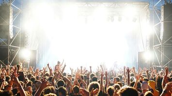 Crowd dancing at an outdoor daytime music event