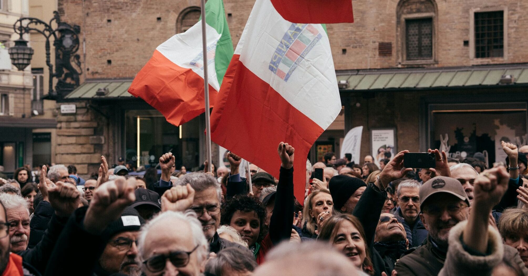 Crowd holding Italian flags during a demonstration