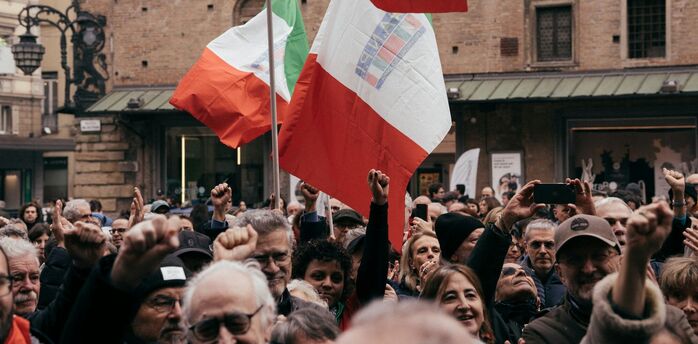 Crowd holding Italian flags during a demonstration