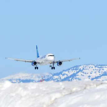 Passenger aircraft approaching a snowy mountain airport