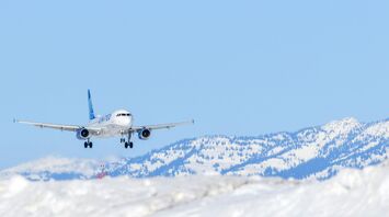 Passenger aircraft approaching a snowy mountain airport