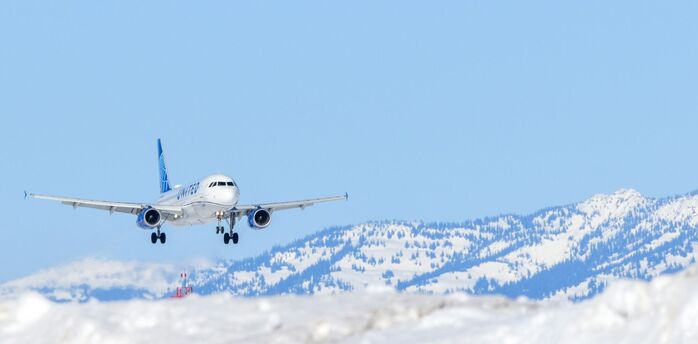 Passenger aircraft approaching a snowy mountain airport